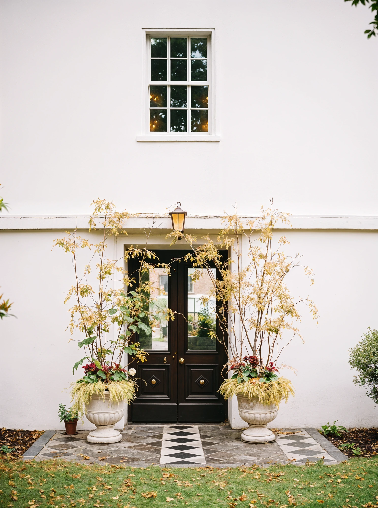 Wedding Ceremony Entrance with Wispy Fall Foliage Arrangements in Changing Colors