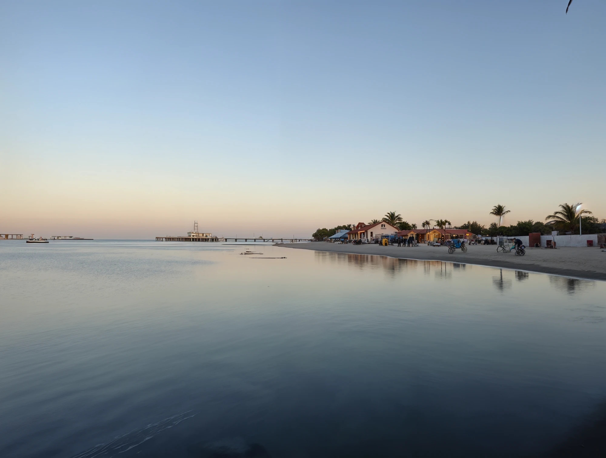 Calm waters with a person paddleboarding nearby distant view of a shoreline with buildings and trees