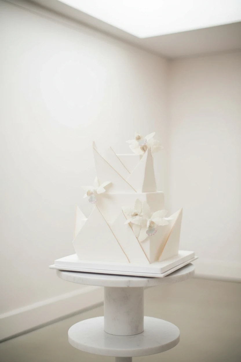 An all-white geometric square cake with white flowers