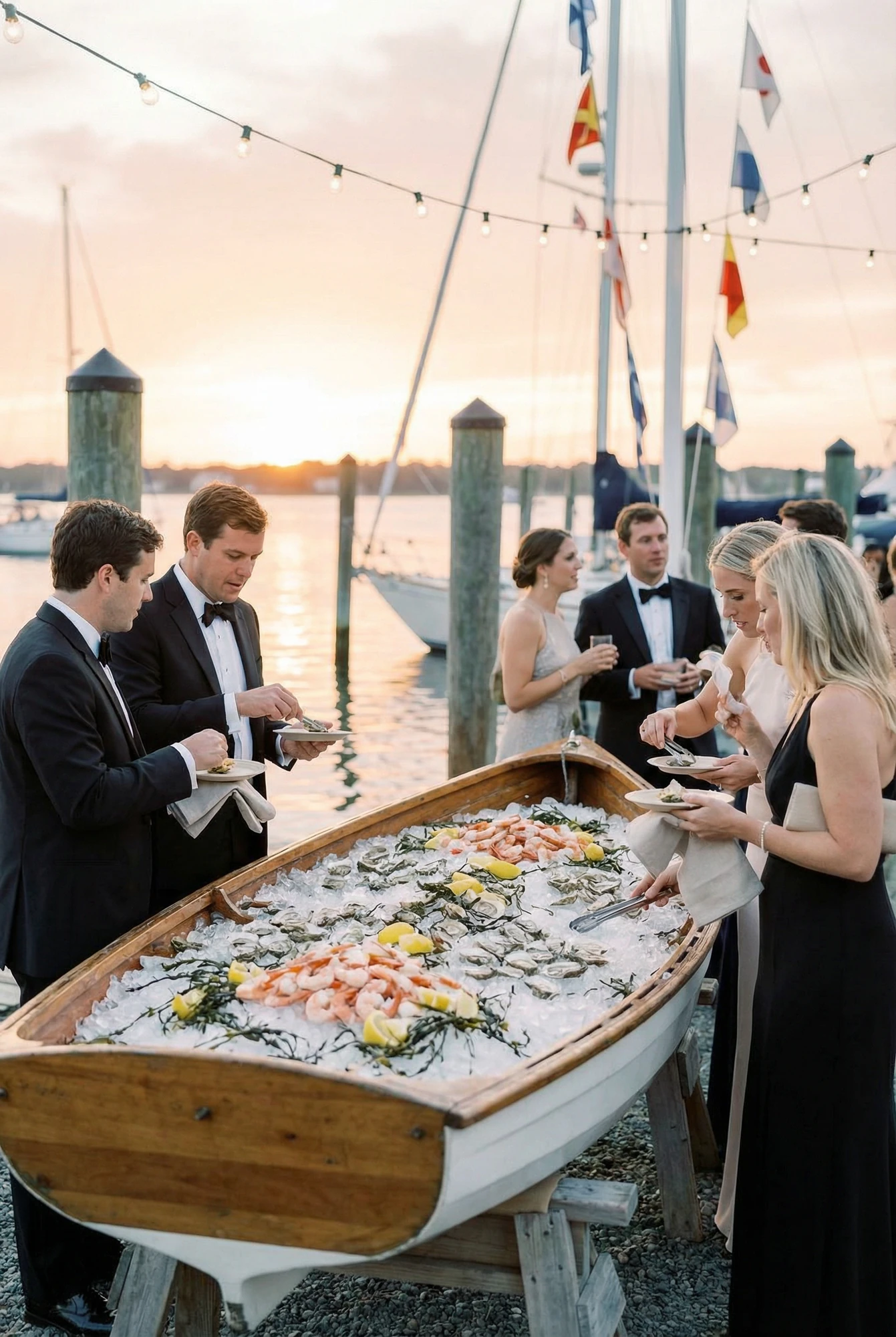 Guests Serving Themselves From a Buffet Positioned Inside a Canoe at an Outdoor Wedding Reception